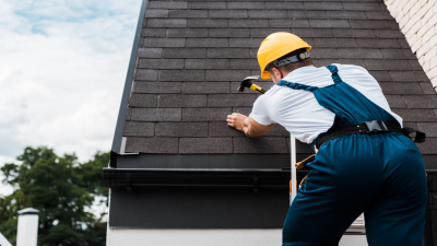 Roofing contractor laying shingles.