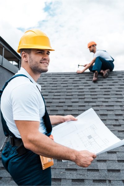 Roofing contractor repairing shingles.